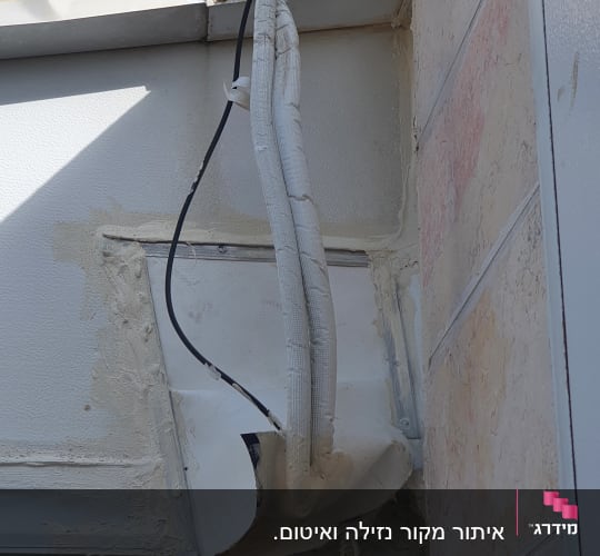 עבודת איטום ותיקון חיצוני על קיר בניין